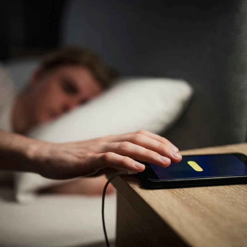 Is it safe to sleep near electronic devices like phones and tablets?